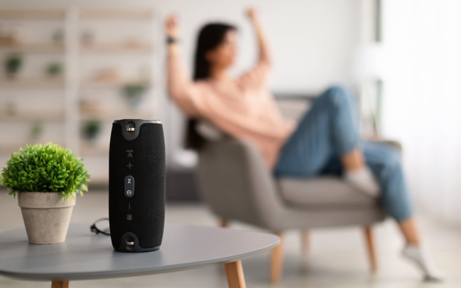 Image of person using wireless speaker