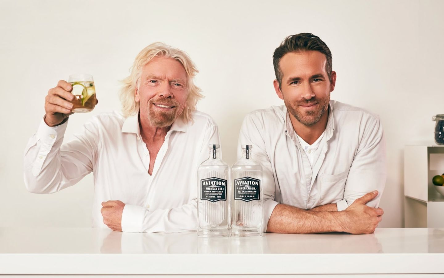Richard Branson and Ryan Reynolds with two bottles of Aviation Gin