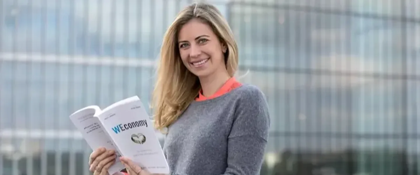 Holly Branson poses with a copy of the book "Weconomy"