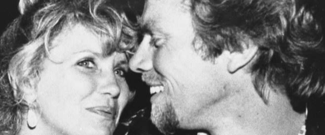 a young Richard Branson and Joan Templeman smile at one another in black and white