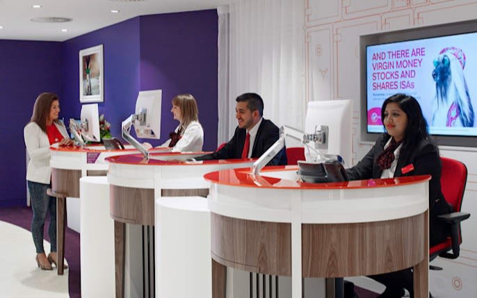 Interior of a Virgin Money branch, with staff sat behind desks