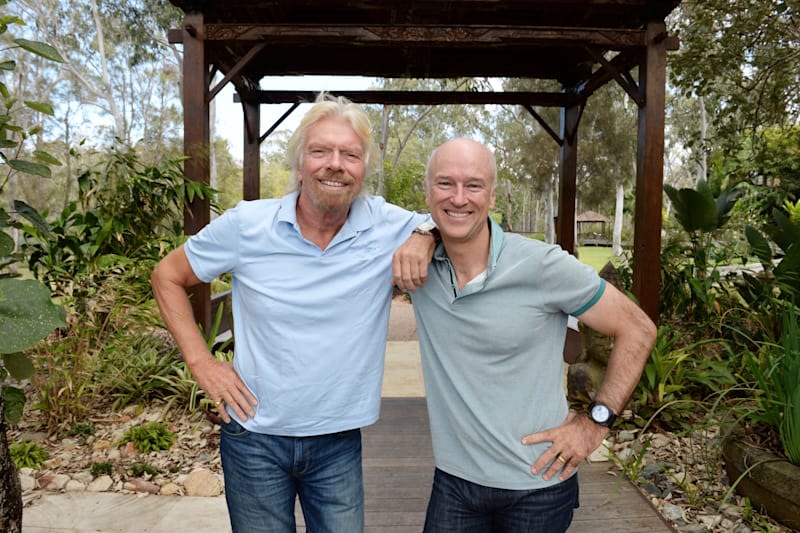 Richard Branson and Brett Godfrey smiling, looking at the camera