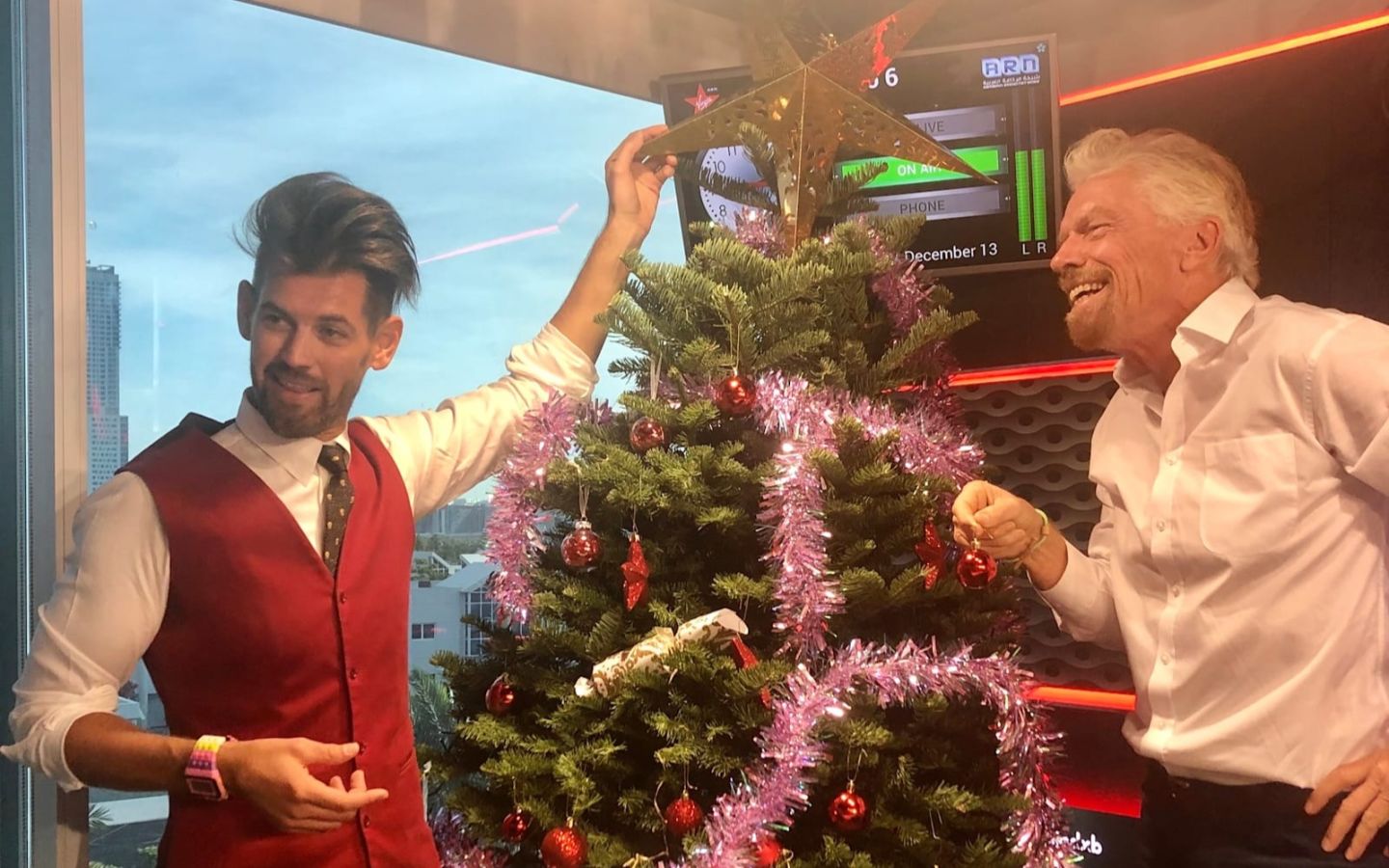 Richard Branson and Brent Black decorate a Christmas tree at Virgin Radio Dubai
