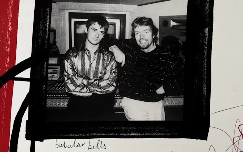 Black and white image of Richard Branson and Mike Oldfield standing together