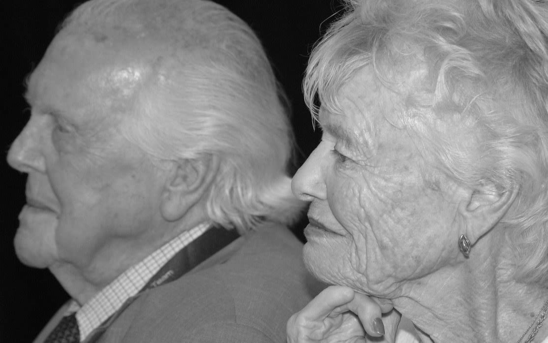 Black and white side profile photo of a older couple 