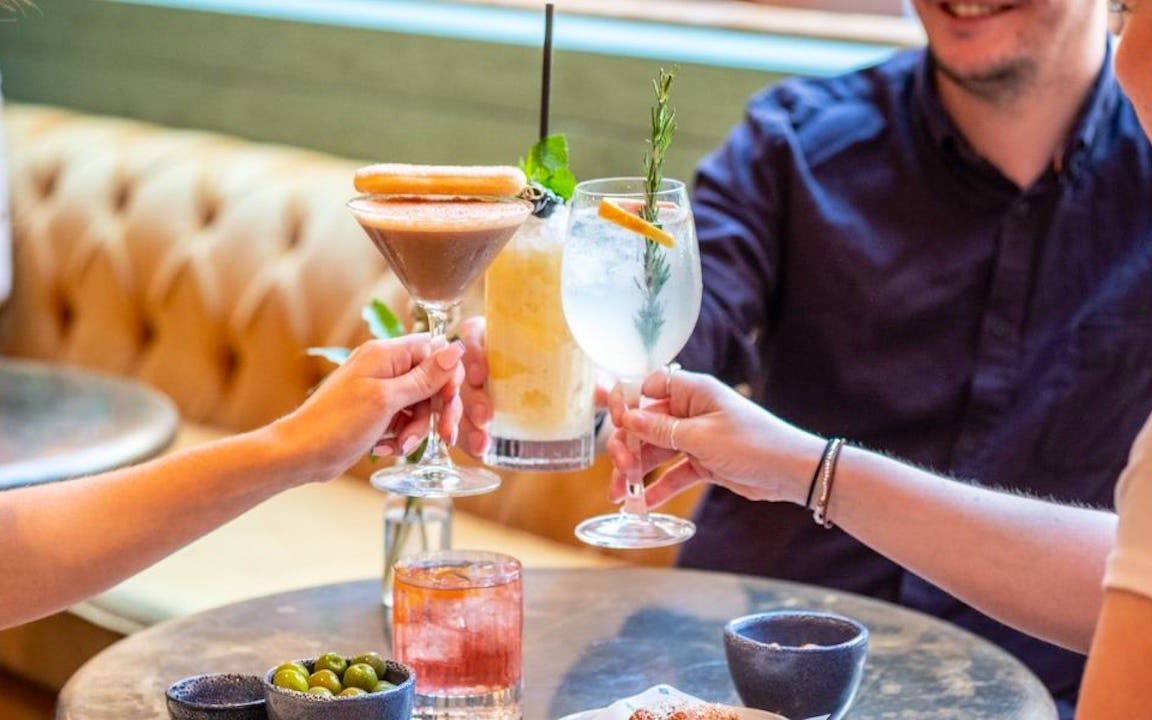 An image of a group of people enjoying cocktails at The Bath Townhouse Coppa Club