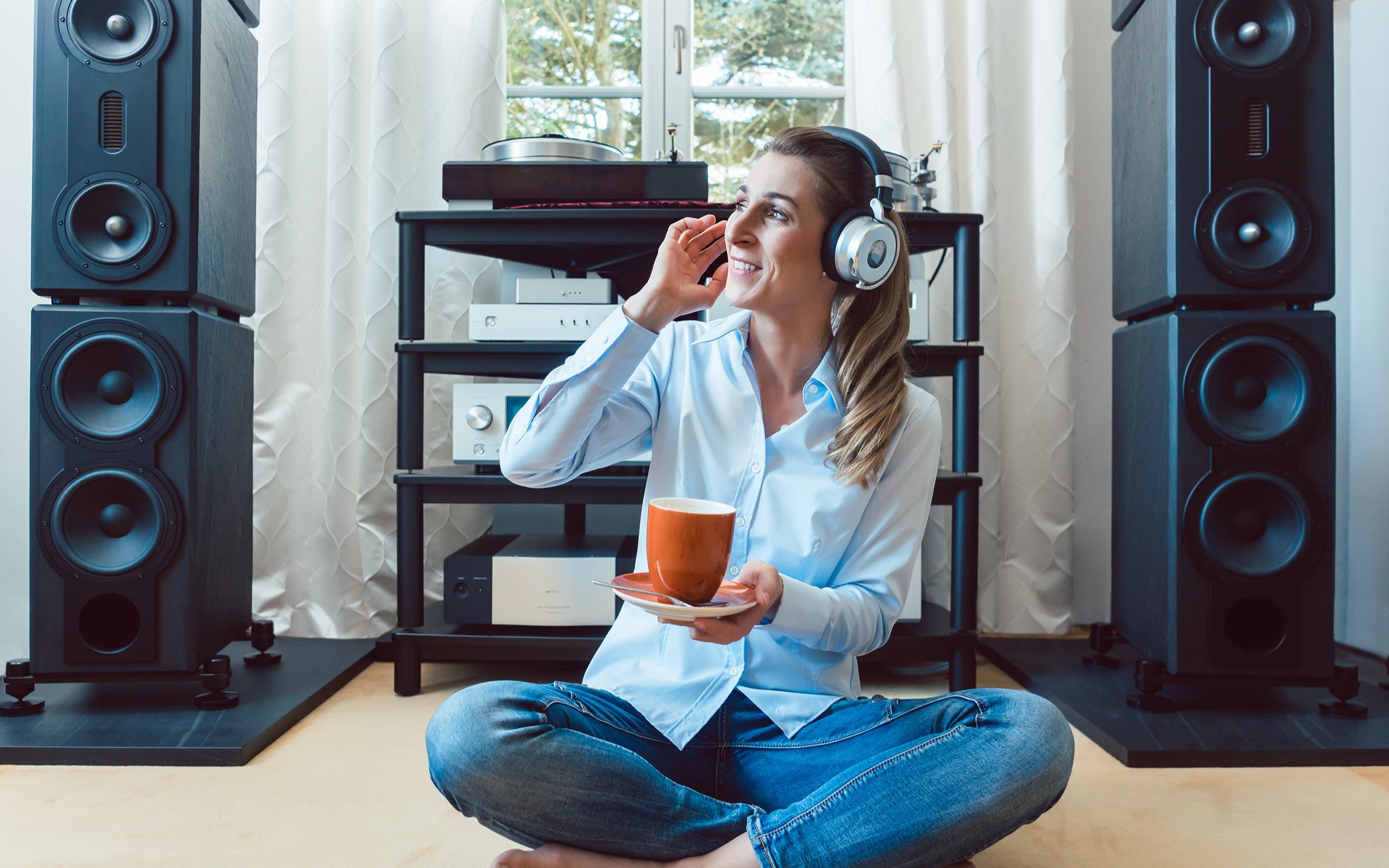 Woman listening to Hi-Fi stereo at home