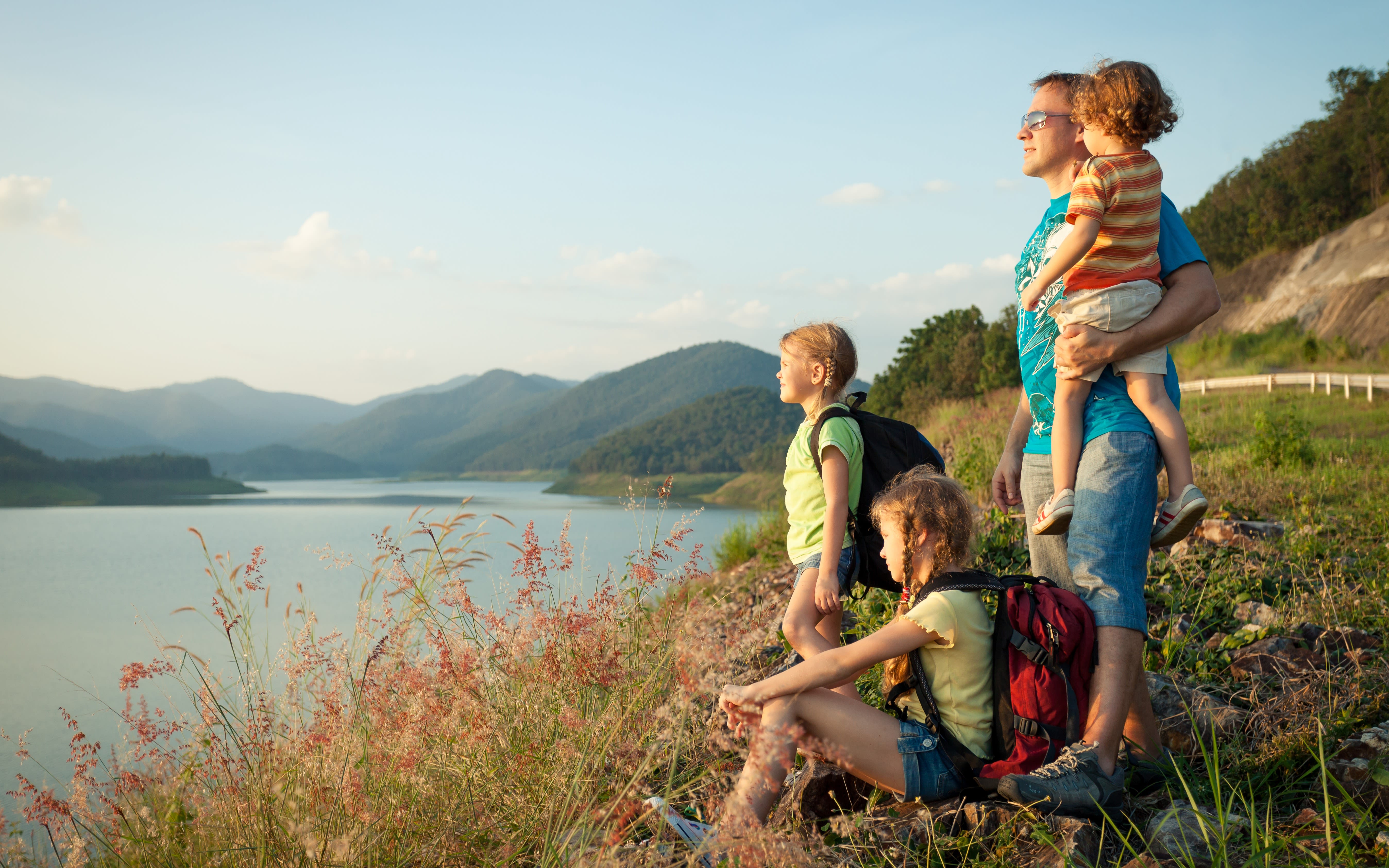 A family enjoying the sunset by the lake