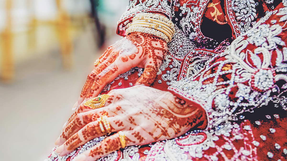 A woman's hands with henna designs on them
