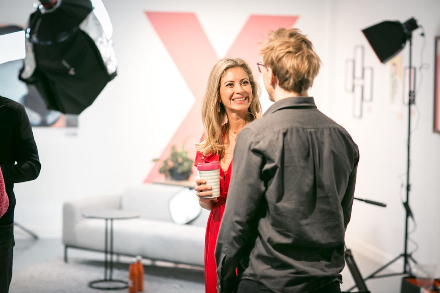 Man talking to Holly Branson on set