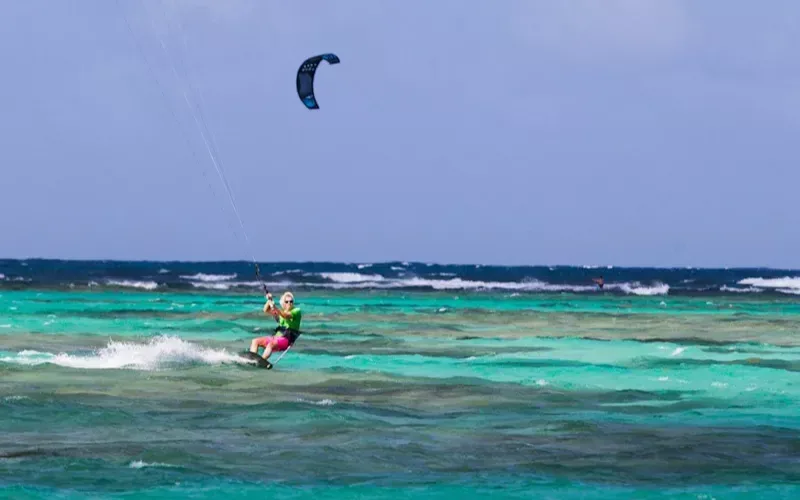Richard Branson kite surfing in the sea on Necker Island