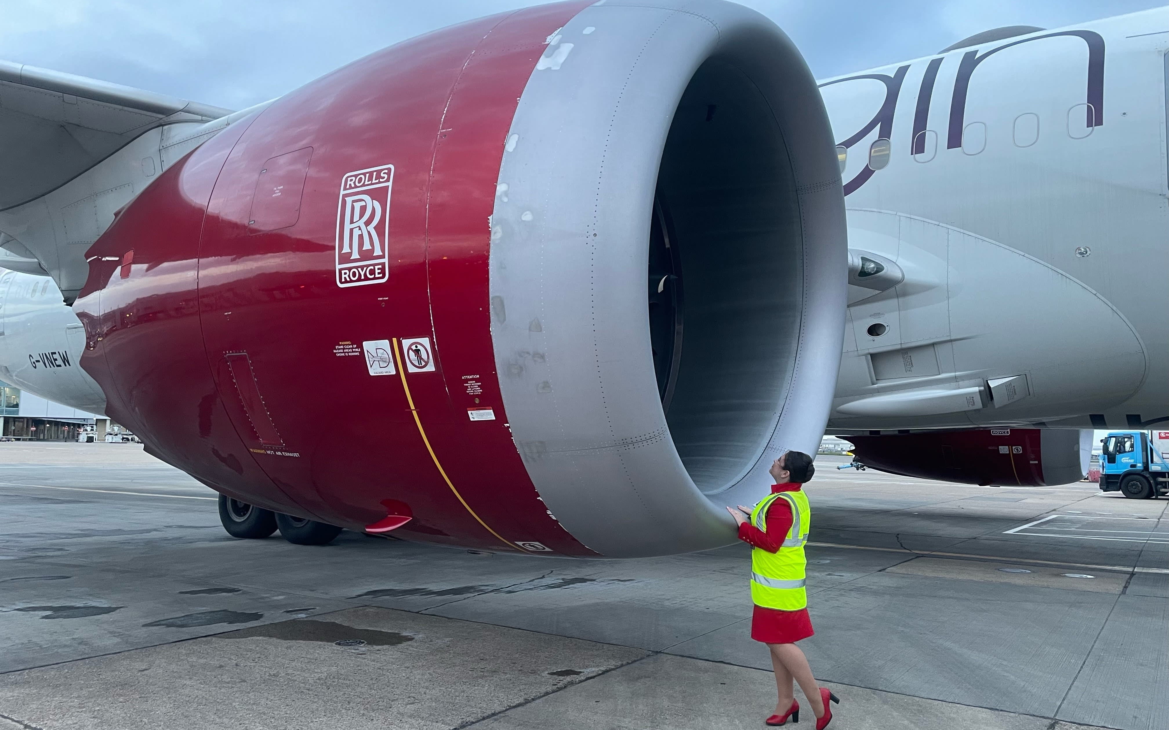 An image of cabin crew Amber stood by a Virgin Atlantic engine