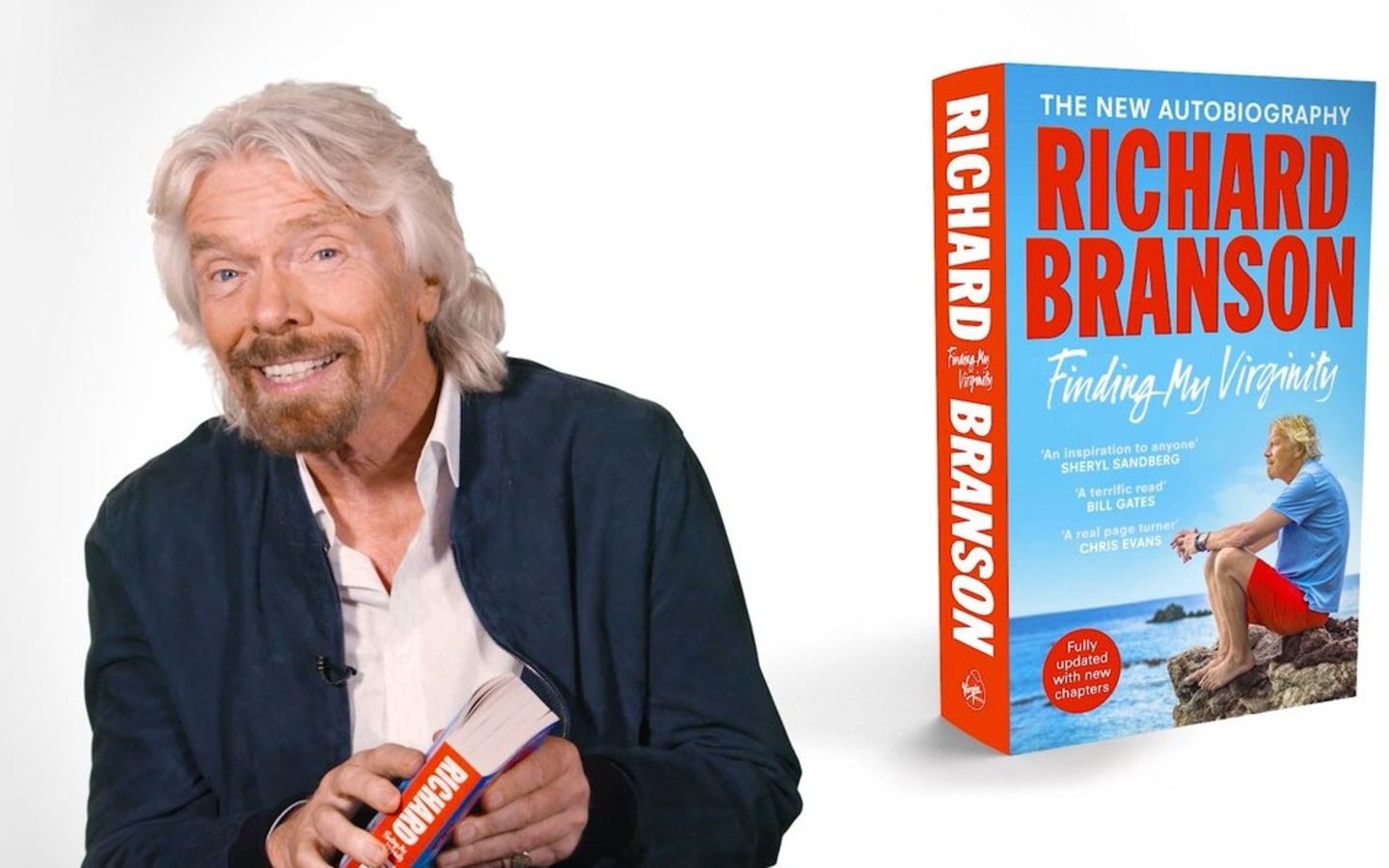 Richard Branson with a paperback copy of his book Finding My Virginity