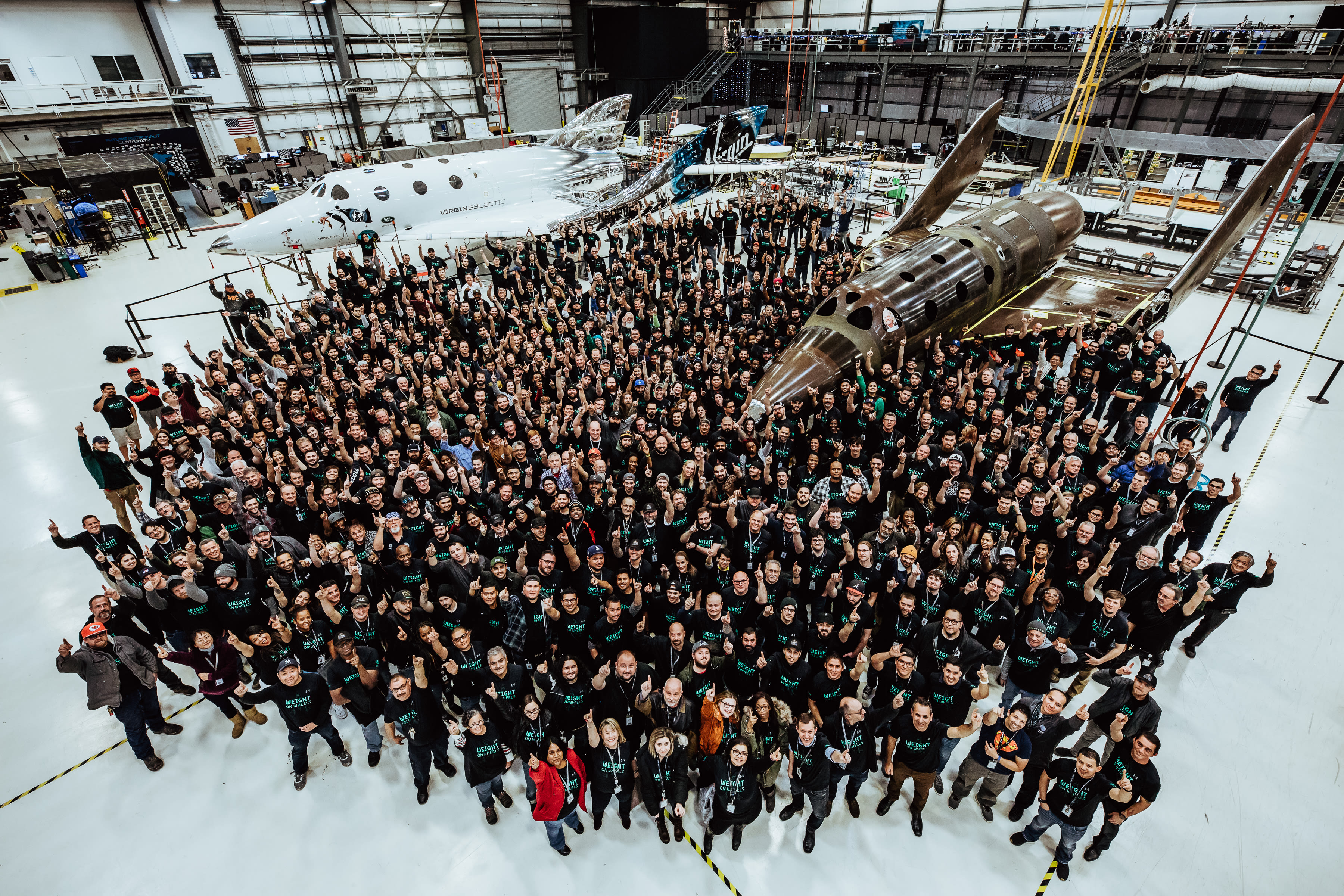 Virgin Galactic team next to their two spaceships