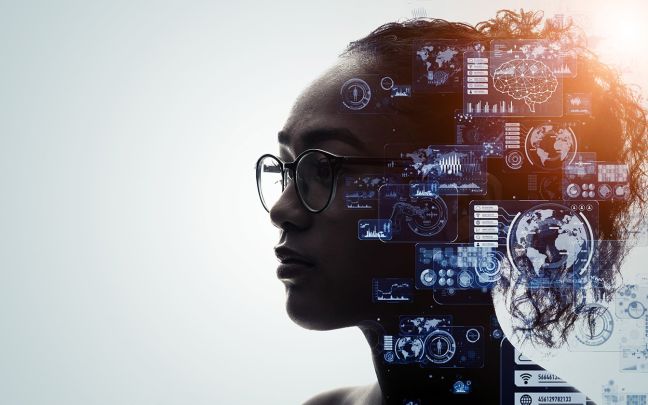A photo of a woman with various technology imagery on the side of her head