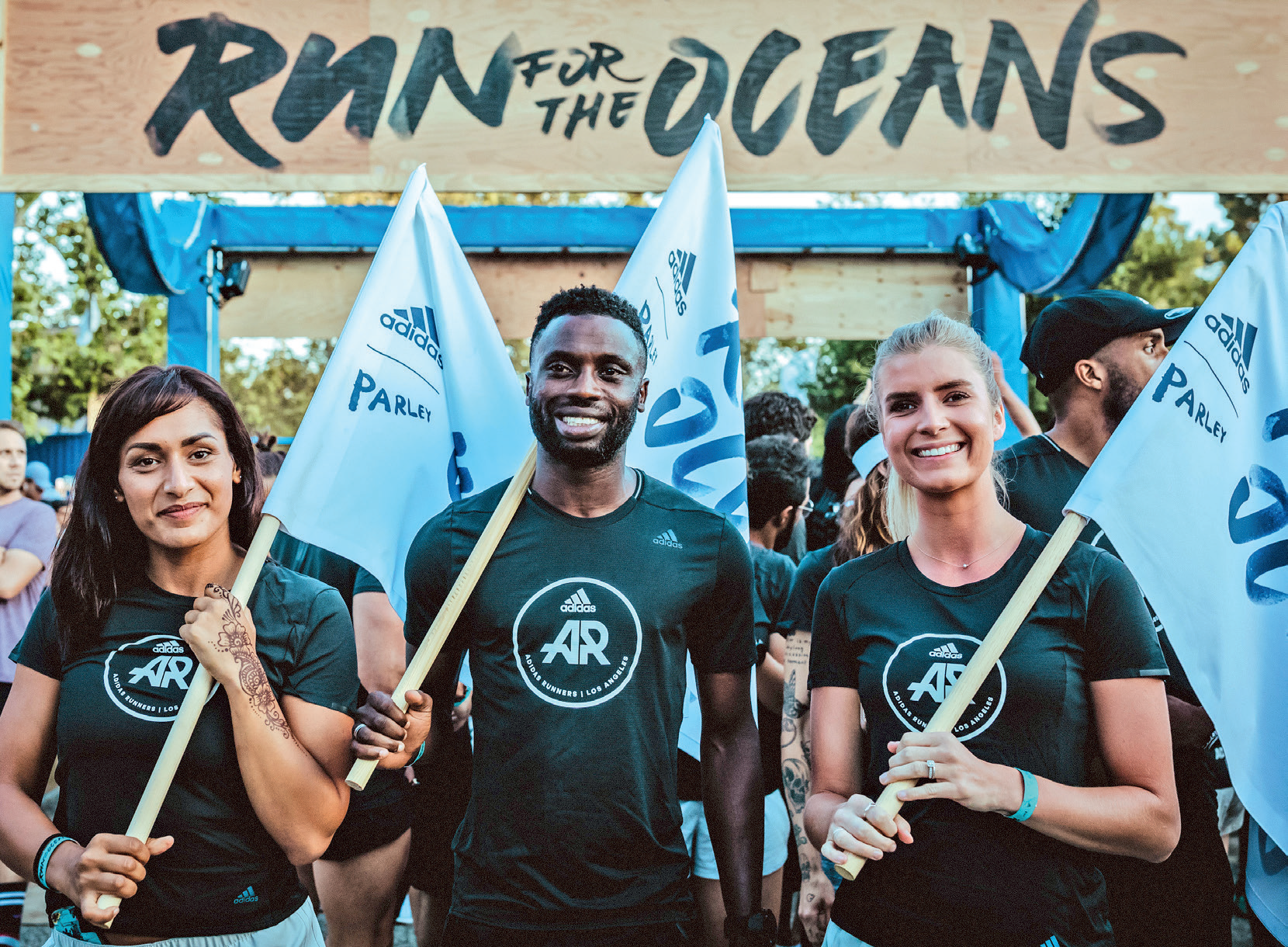 Ayo Dada with fellow Adidas runners holding Run For The Oceans flags