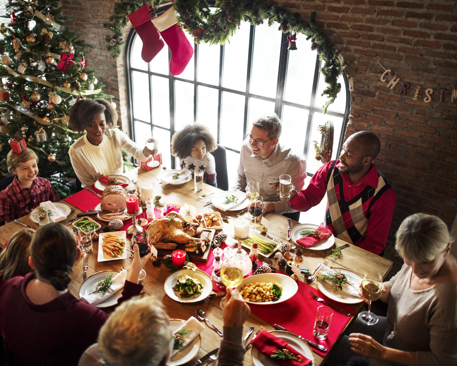 A family gathering round a table for Christmas dinner