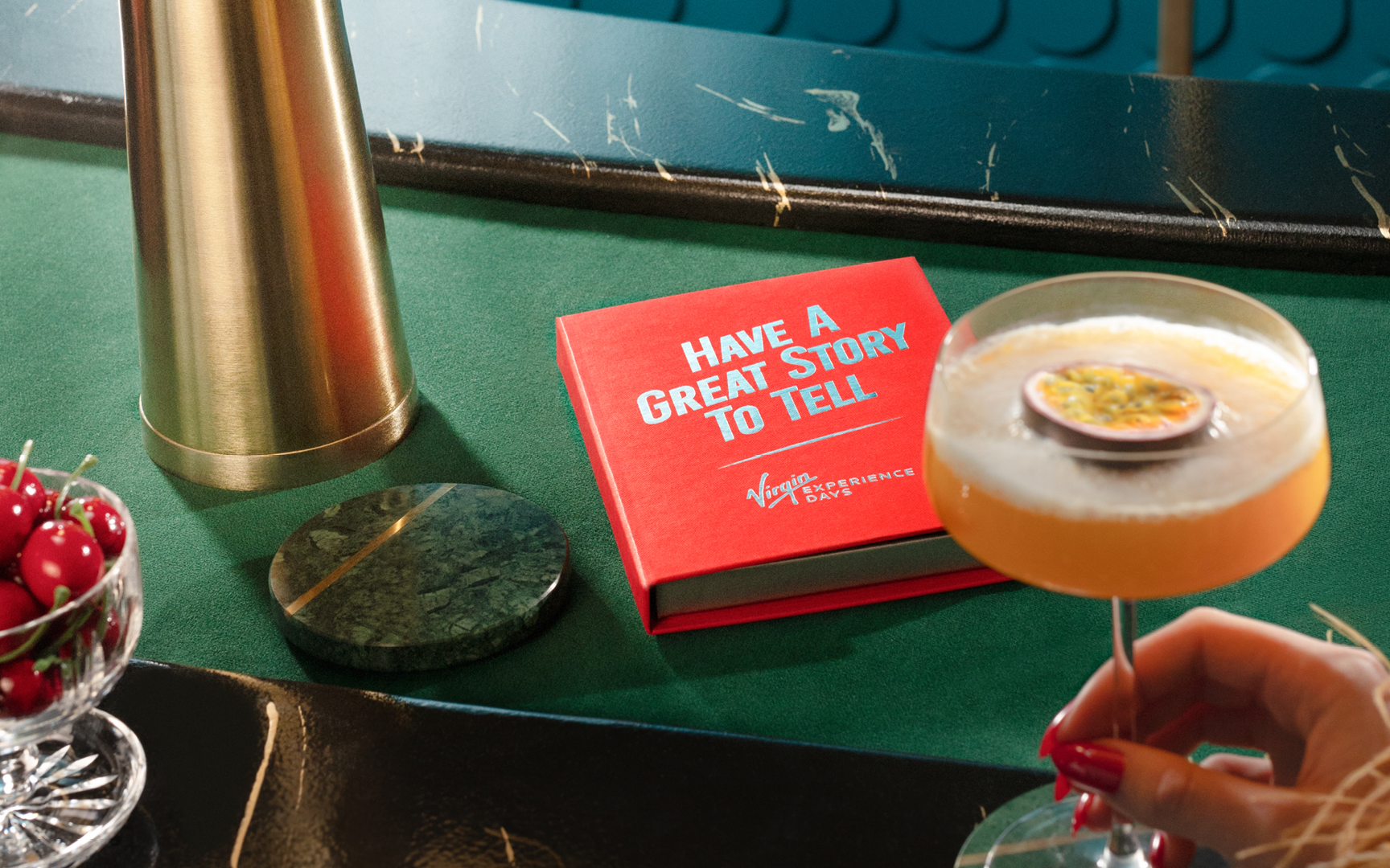An image of a Virgin Experience Days voucher box next to a cocktail.