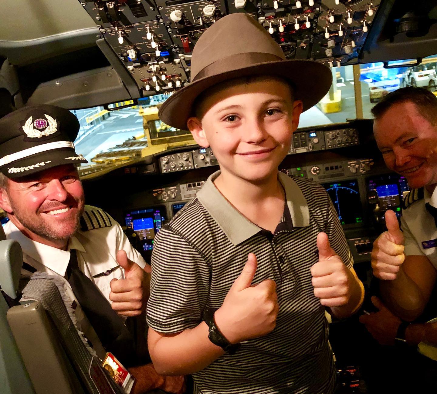 Angus Copelin-Walters smiles in the flight deck of a Virgin Australia plane