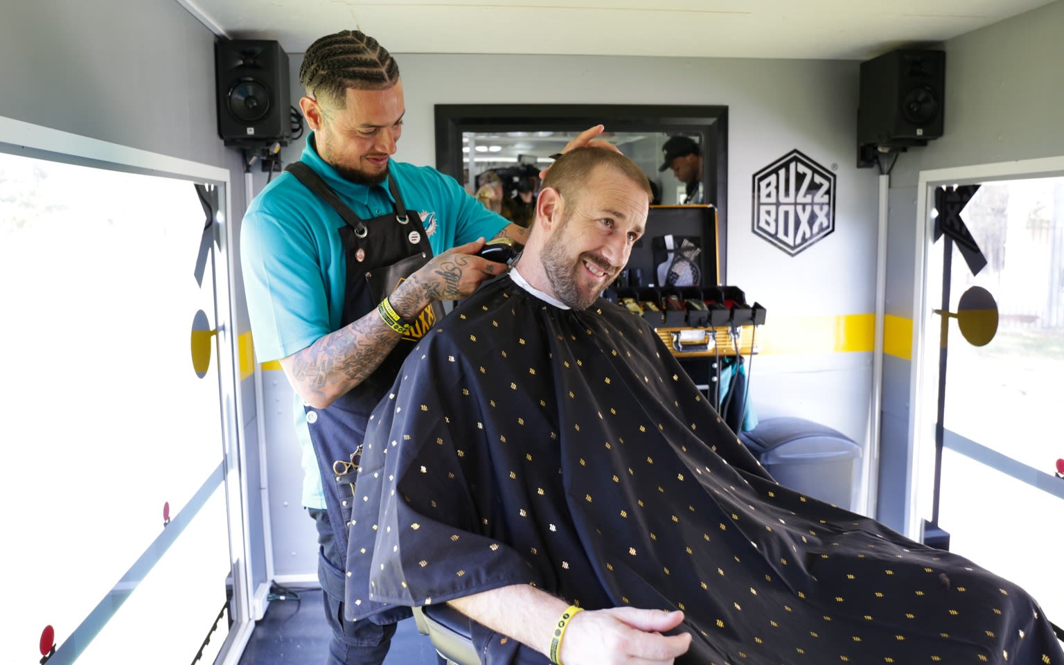 A man gets his hair cut on Virgin Trains' Buzz Boxx