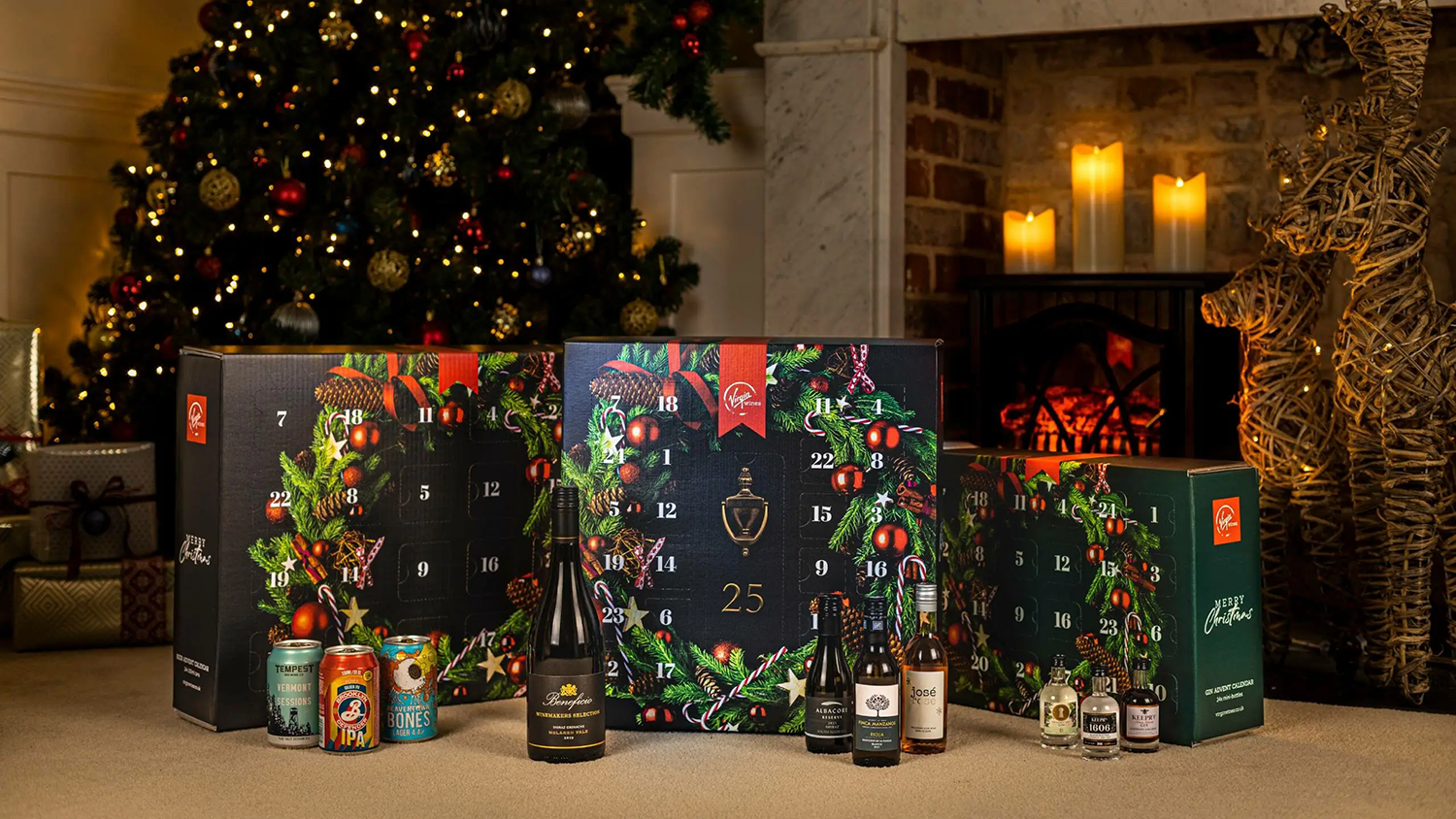 Three Virgin Wines alcohol advent calendars in front of a Christmassy scene