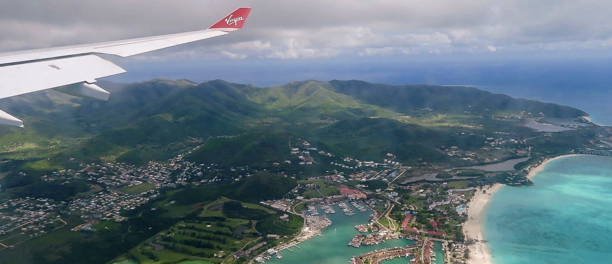 The wing of a Virgin Atlantic aircraft on approach to Antigua