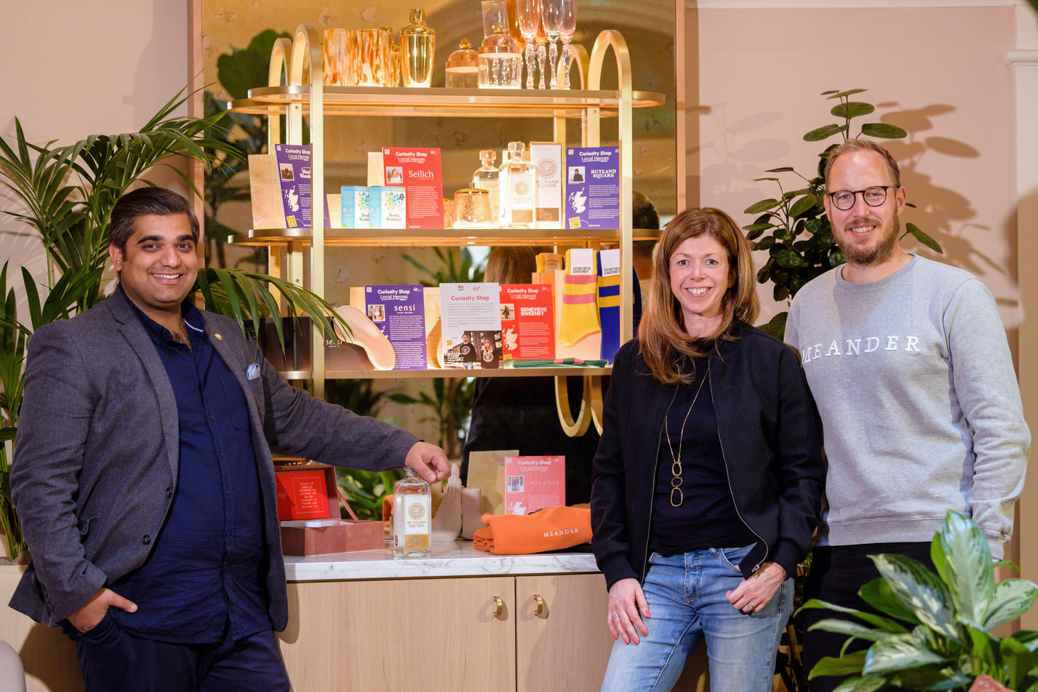Nishant Sharmer and Jill and Steve Henry next to The Curiosity Shop display at Virgin Hotels Edinburgh