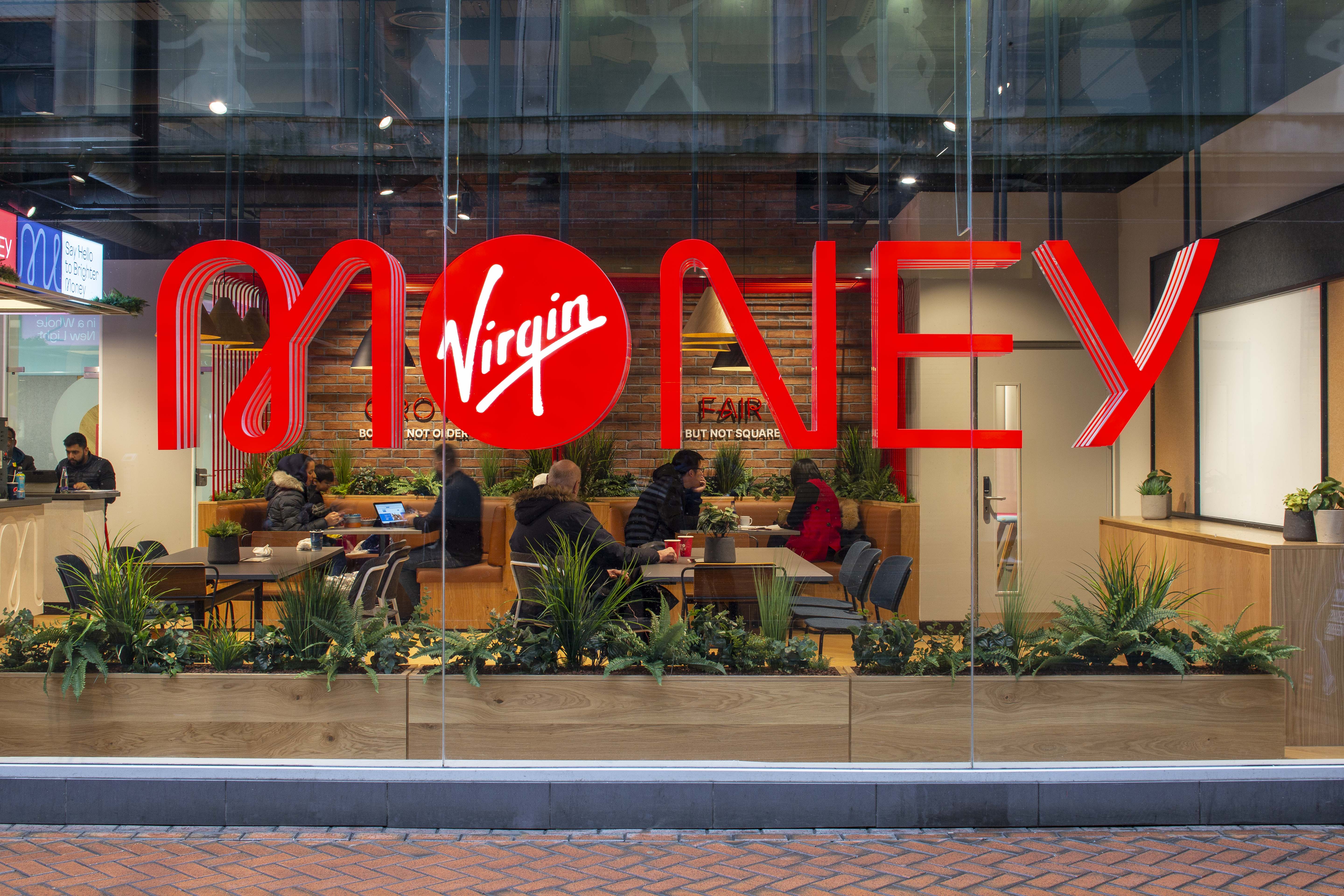 A Virgin Money outside a Virgin Money store, with people in the background inside the store