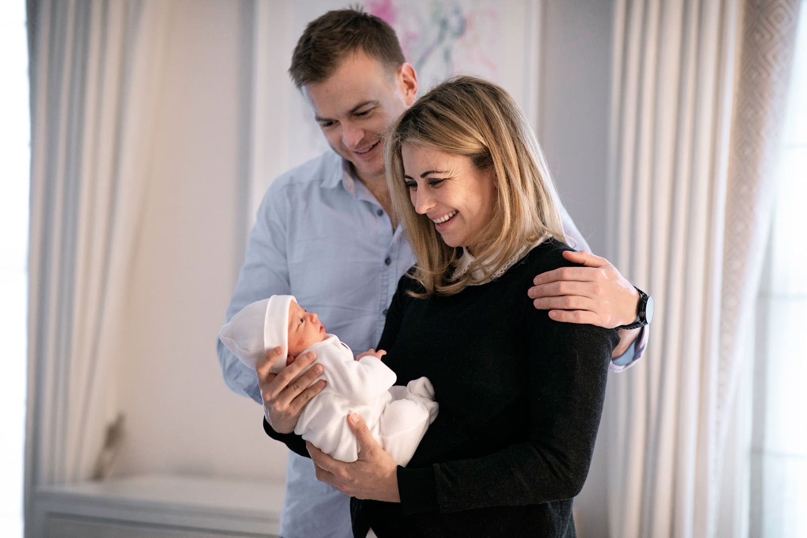 Holly Branson and husband Freddie Andrewes looking at baby daughter Lola