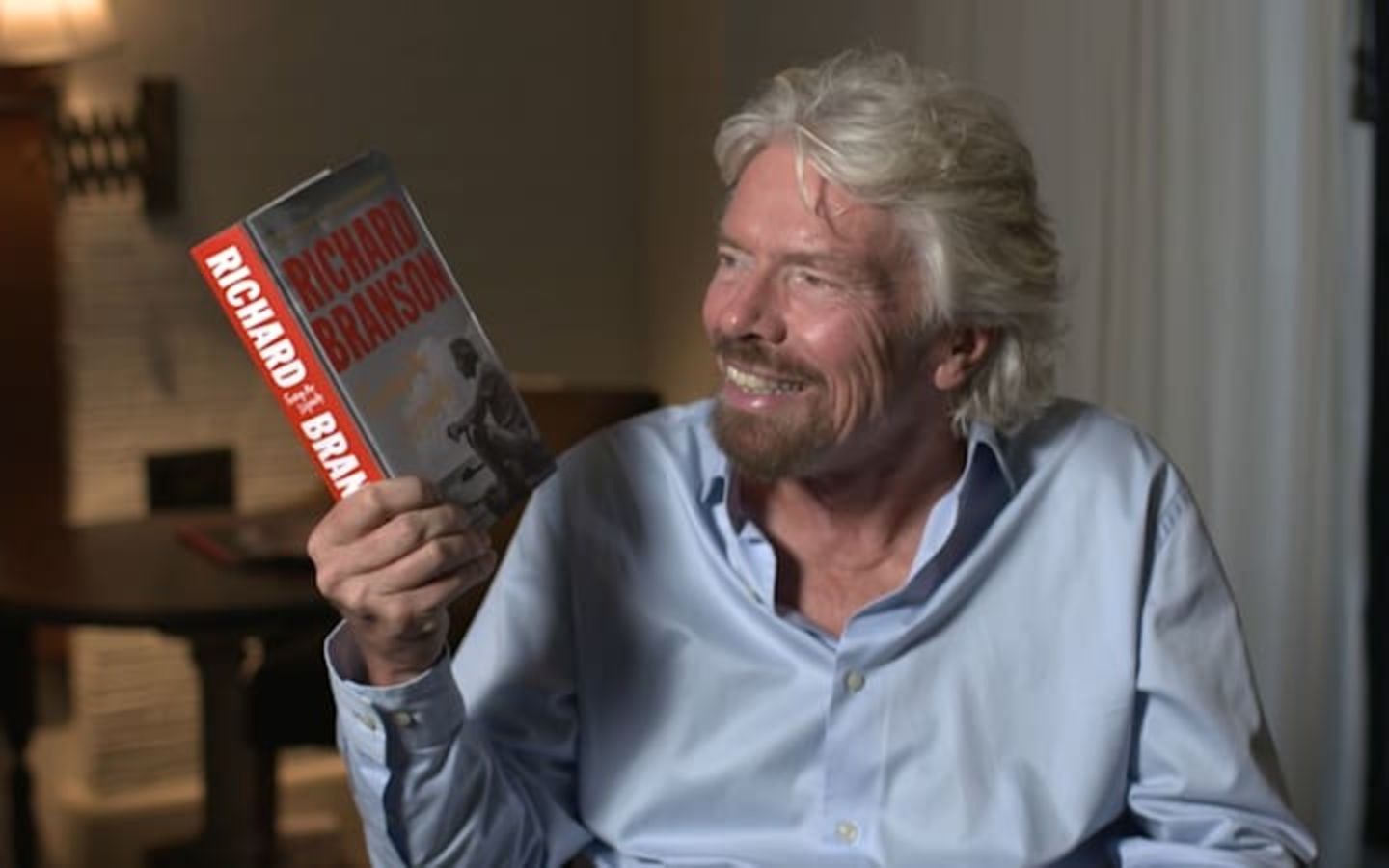 Richard Branson holding a book