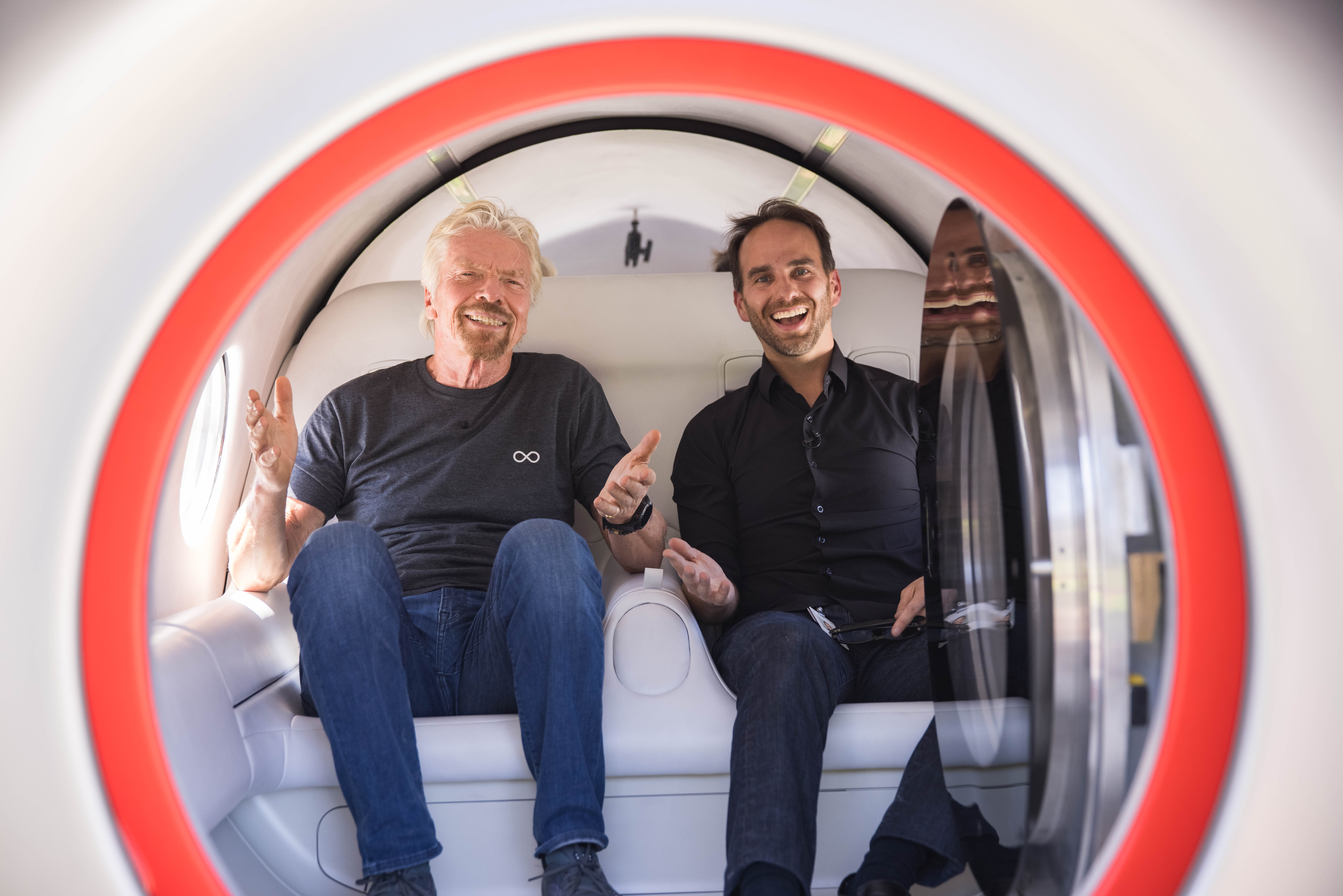 Richard Branson and Josh Giegel siting in the Virgin Hyperloop test pod