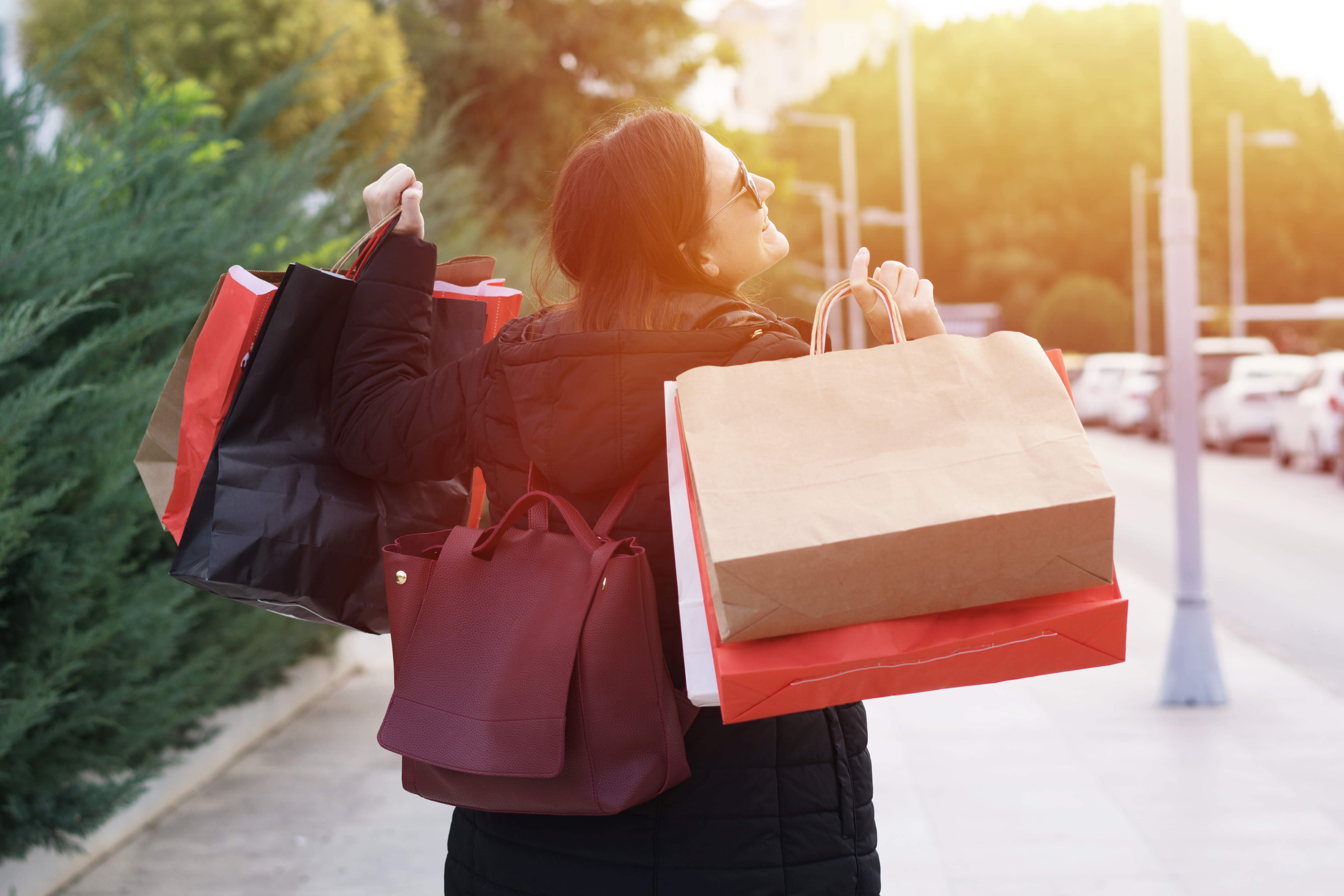 woman who is happy carrying shopping bags