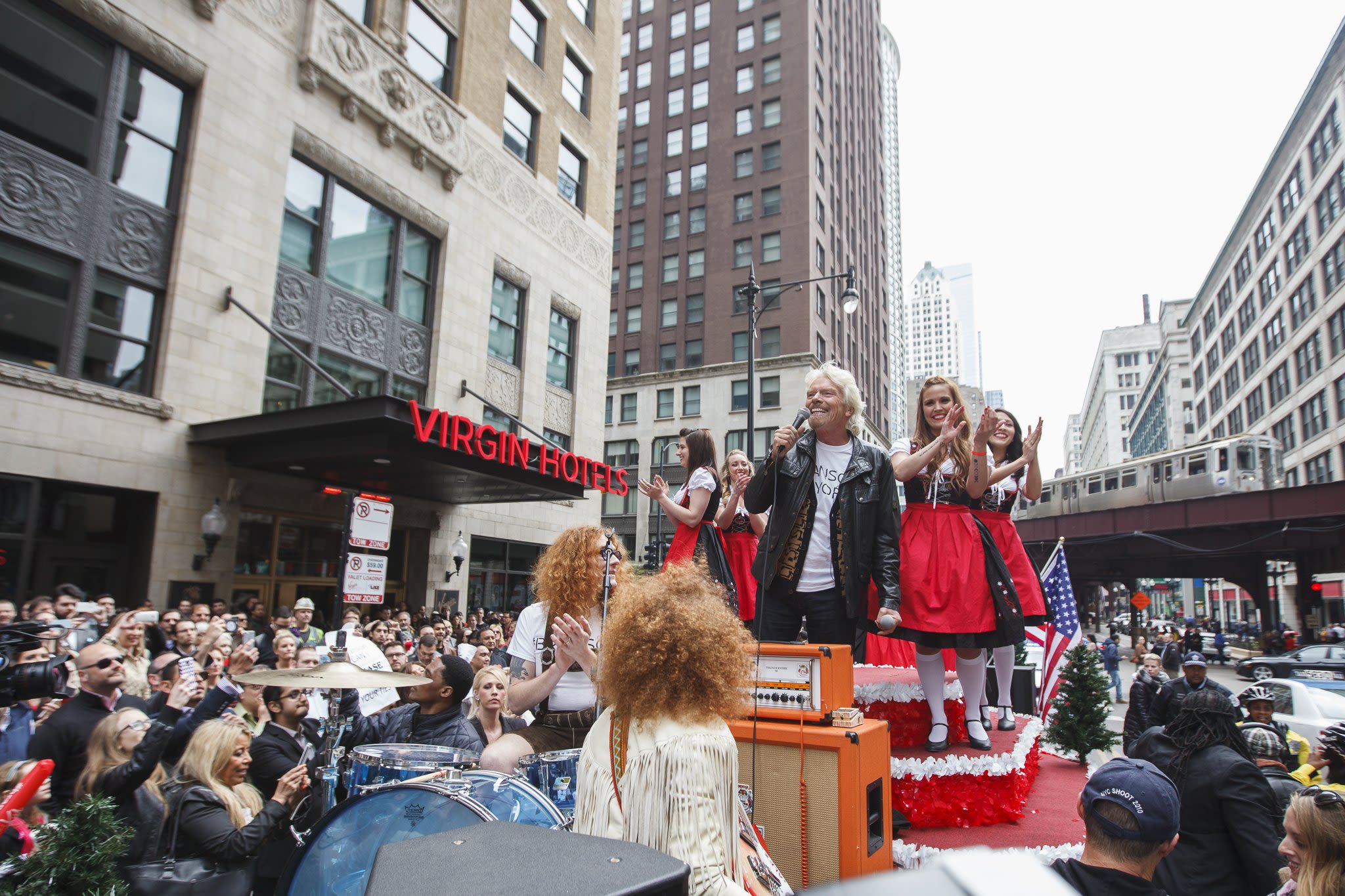 Richard Branson sings on a float outside Virgin Hotels Chicago