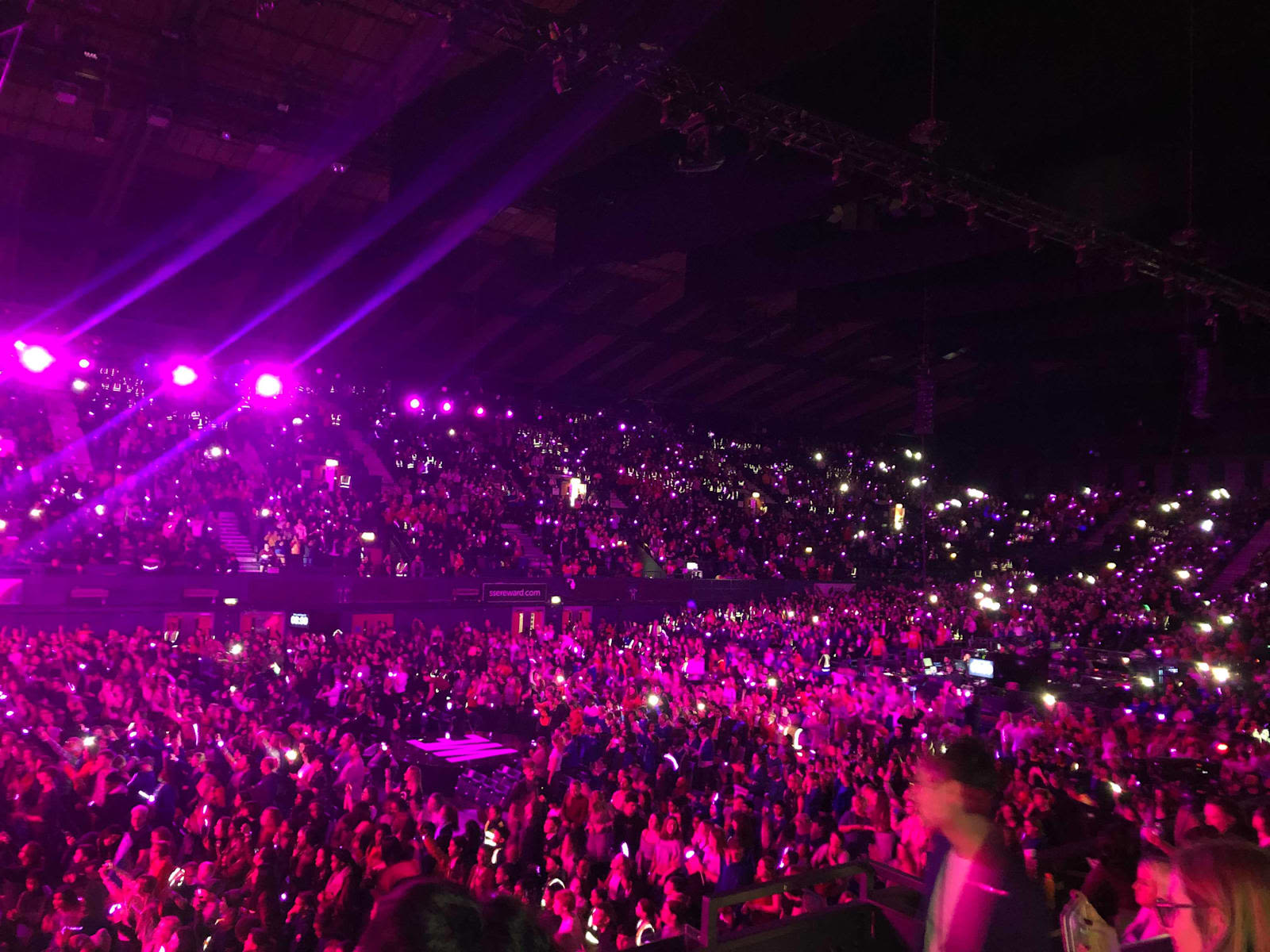 Picture of the crowd at WE Day, lit by purple lighting 