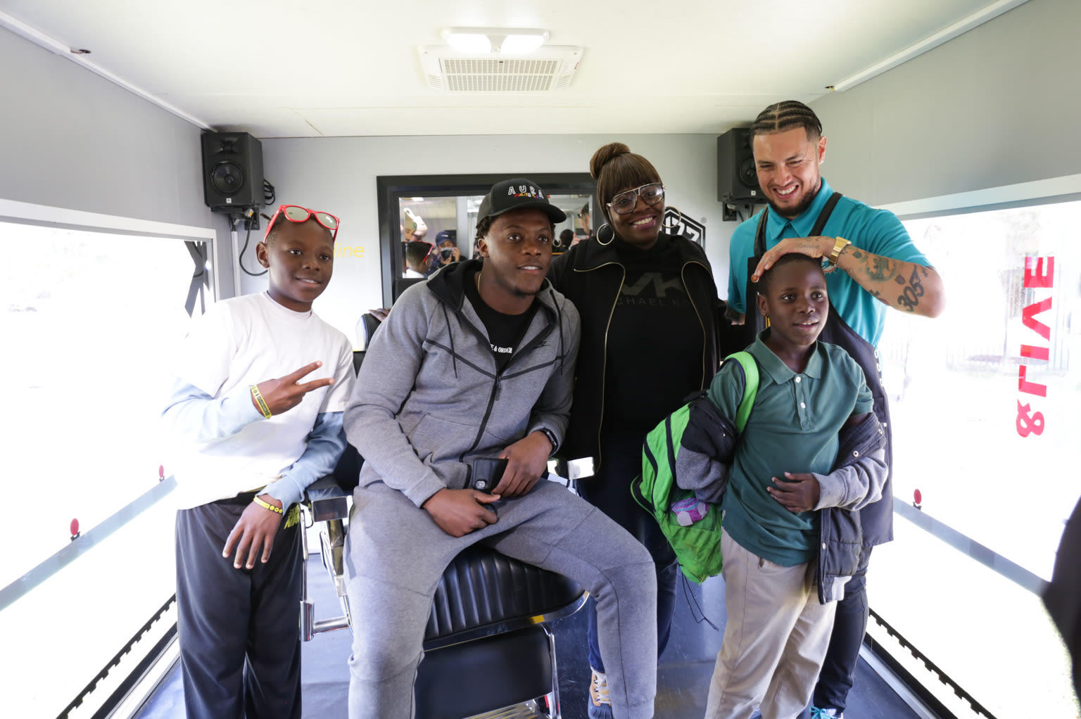 Boys pose for a photo after having their haircut at Virgin Trains' Buzz Boxx event