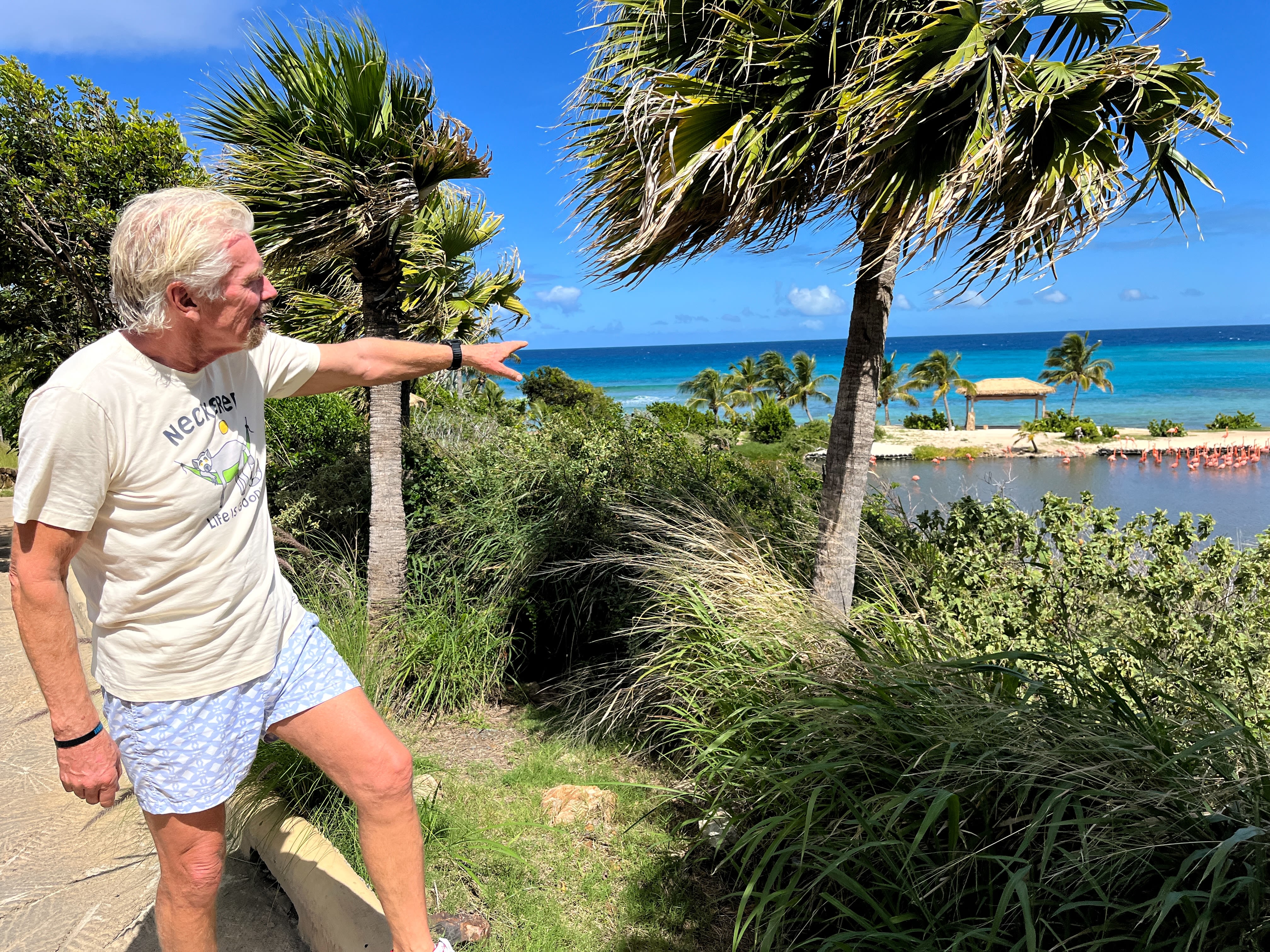 Richard Branson pointing at the flamingos on Necker Island
