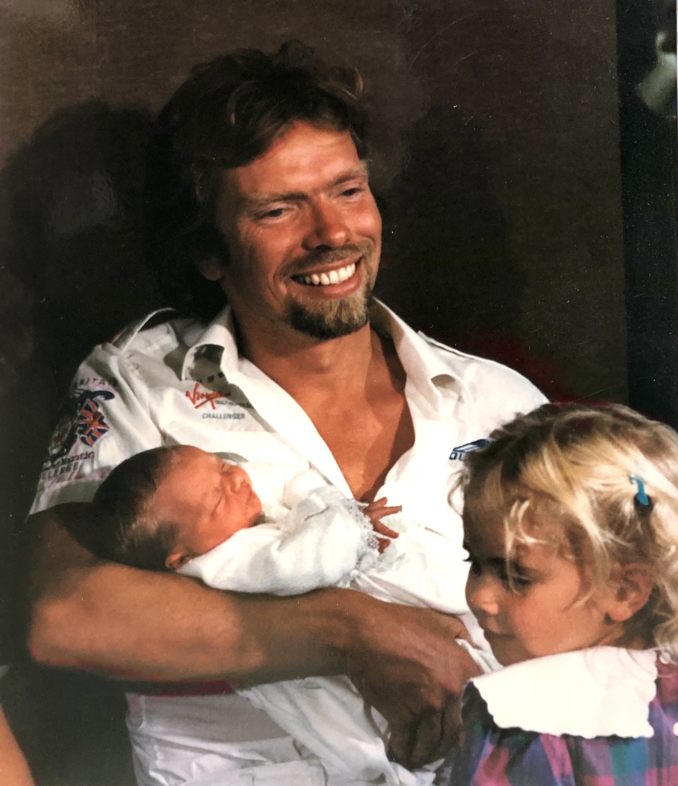 Richard Branson holding Sam Branson after his birth, post the Virgin Atlantic Challenger