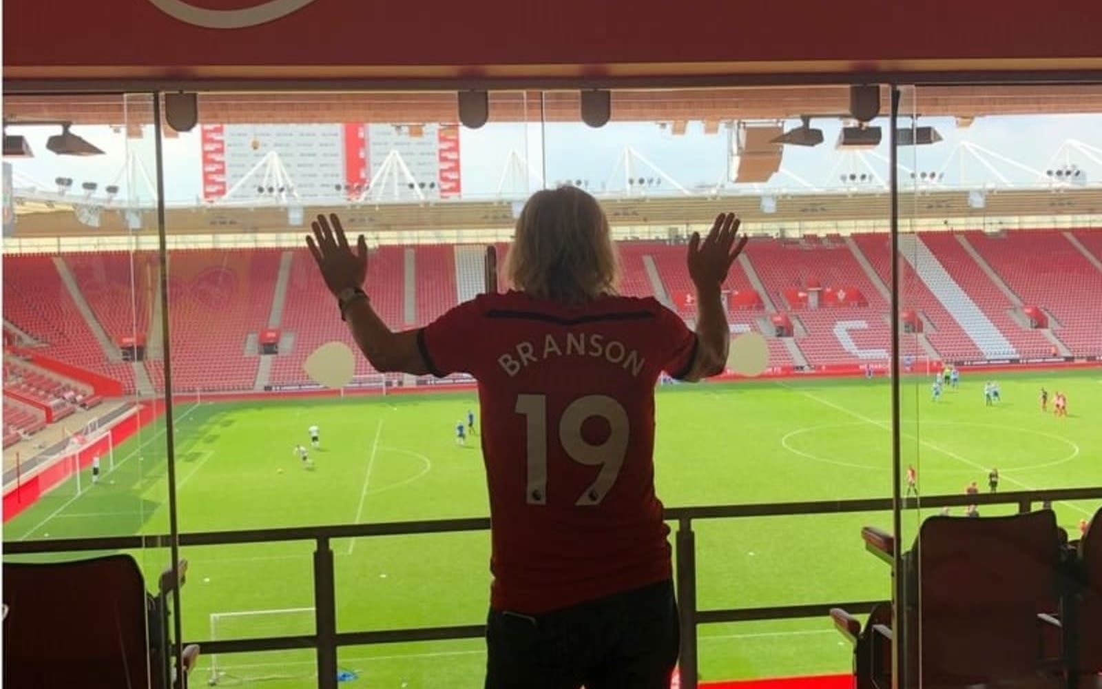 Richard Branson looking out at Southampton Football Club field in 2019