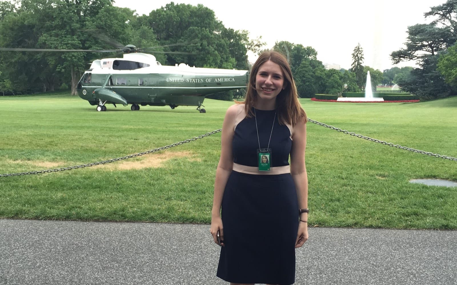 Molly Dillon standing with a helicopter behind her 