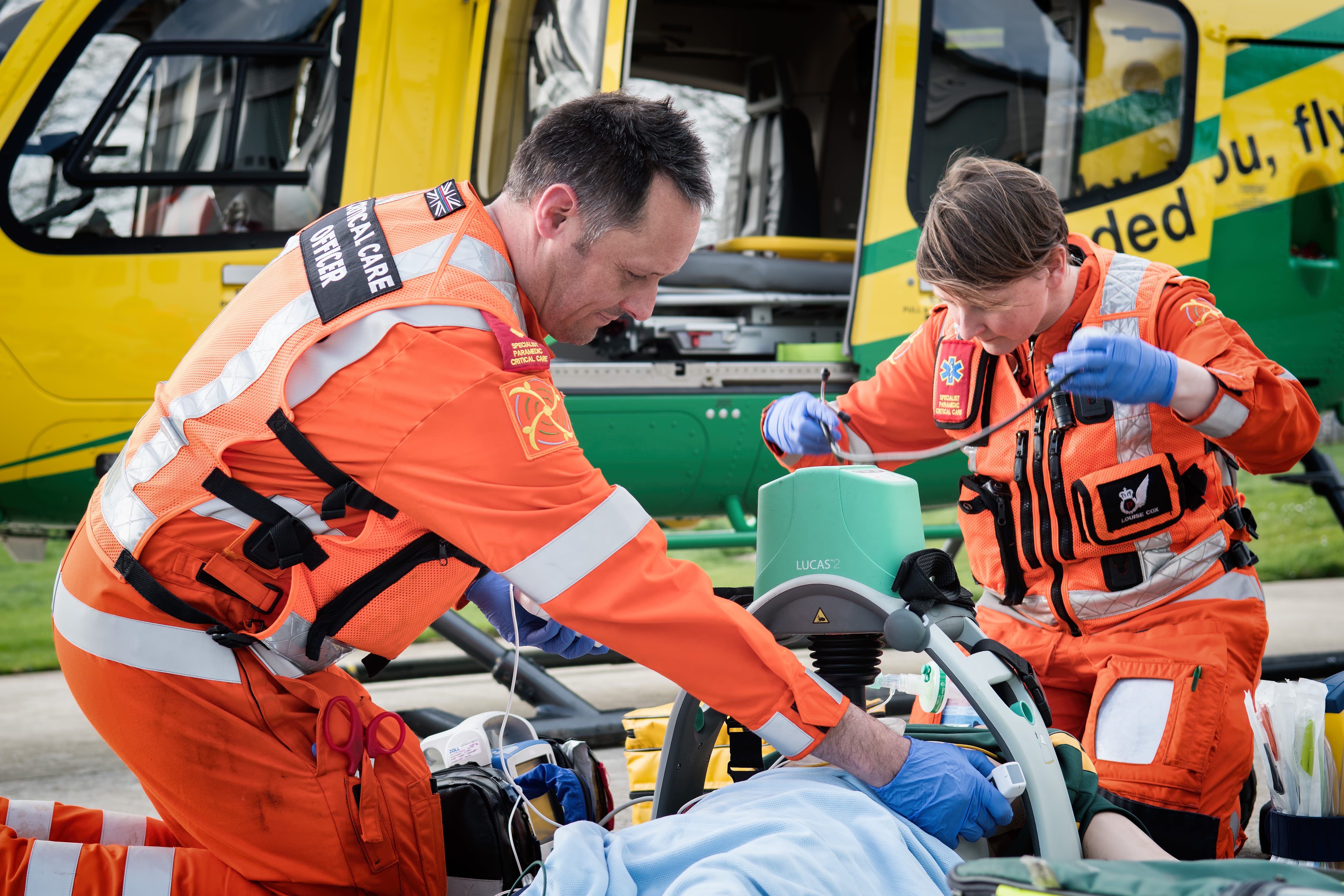 Image of two Air Ambulances paramedics from Wiltshire Air Ambulance rescuing an individual in need of medical attention.