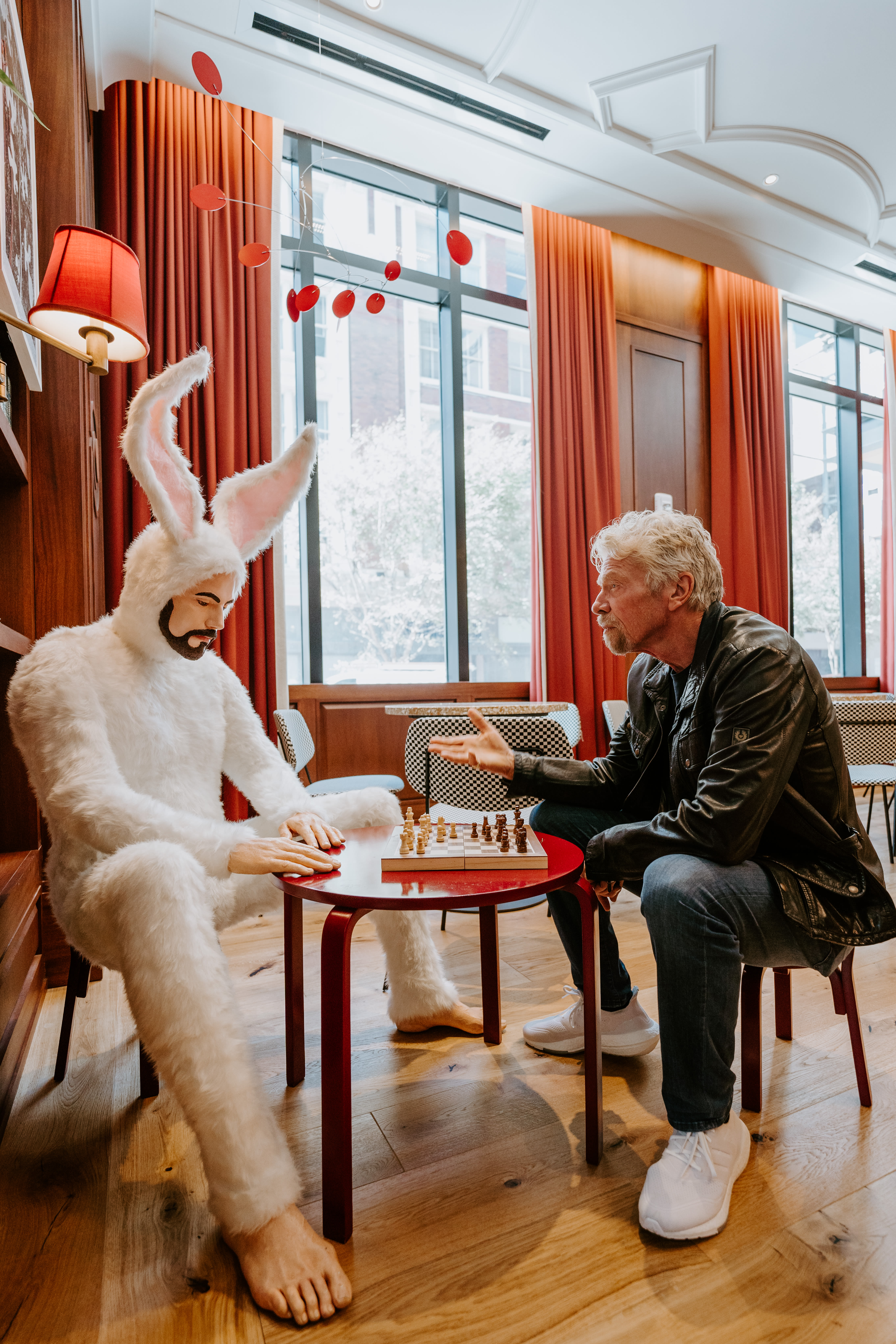 Richard Branson playing chess with a bunny at Virgin Hotels New Orleans