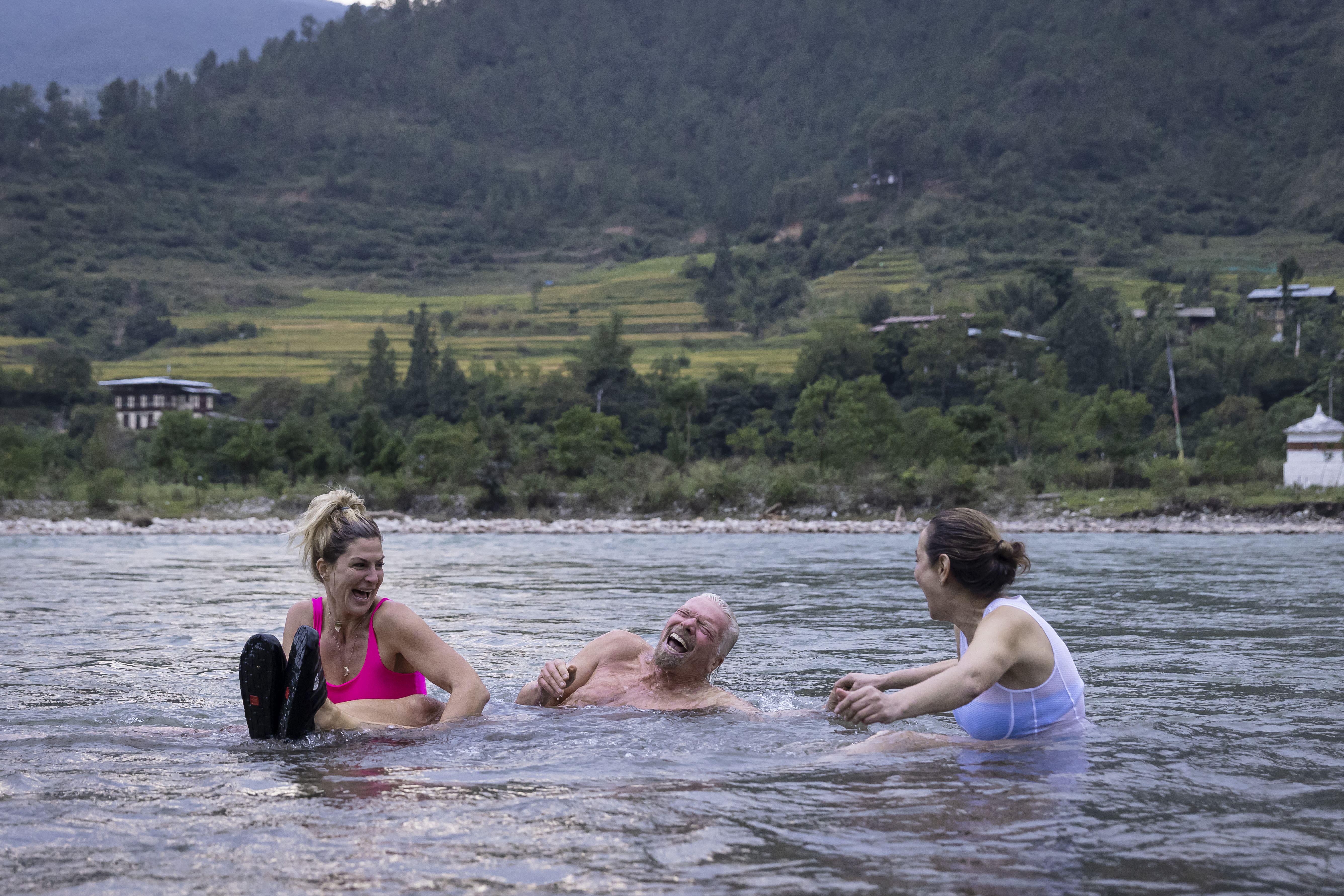Richard Branson laughing in a lake in Bhutan