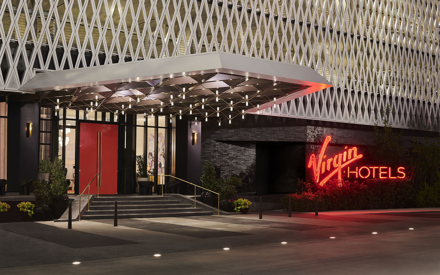 The entrance to Virgin Hotels Dallas, a red neon sign reads Virgin Hotels