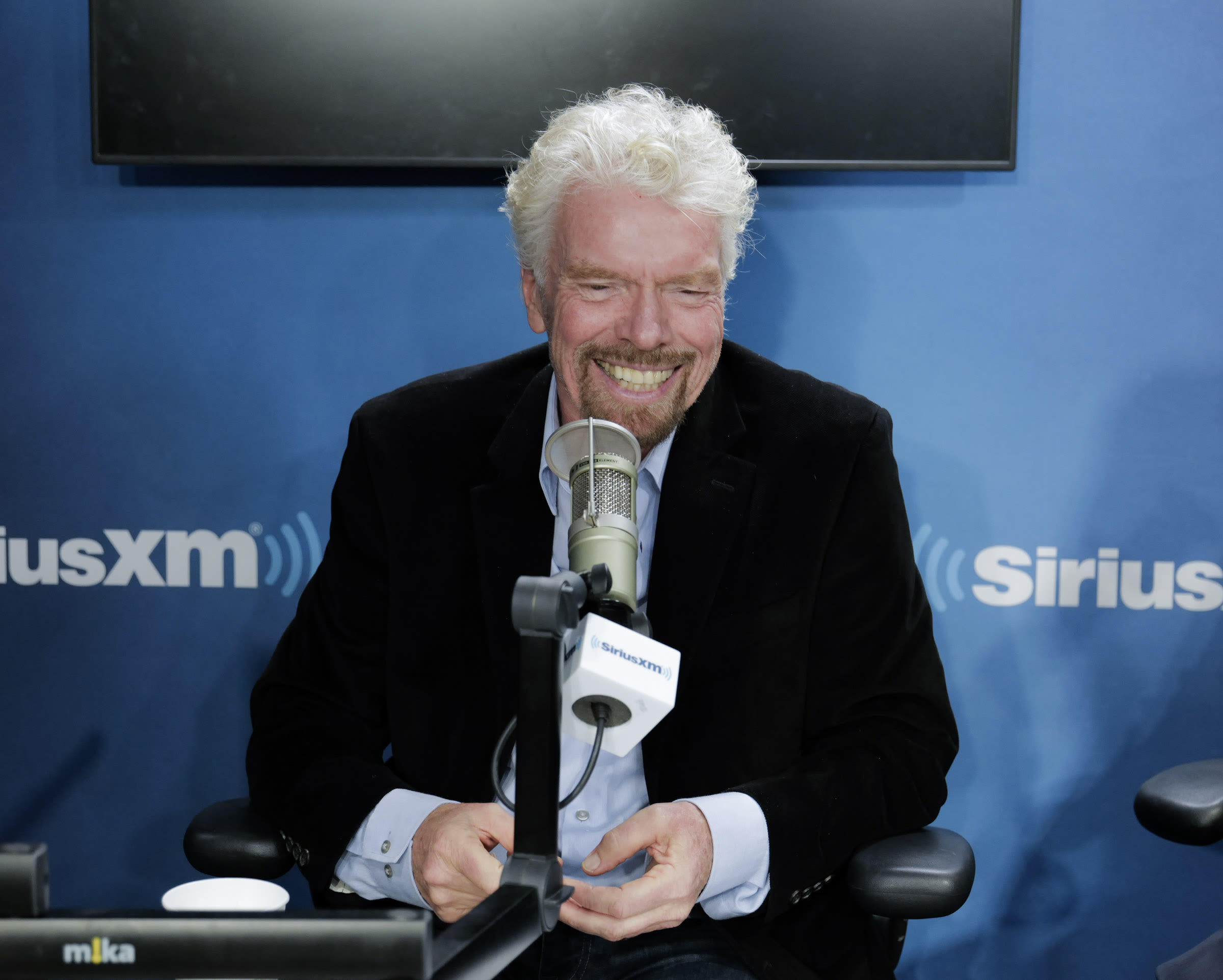 Richard Branson sat in the Sirius XM studio smiling