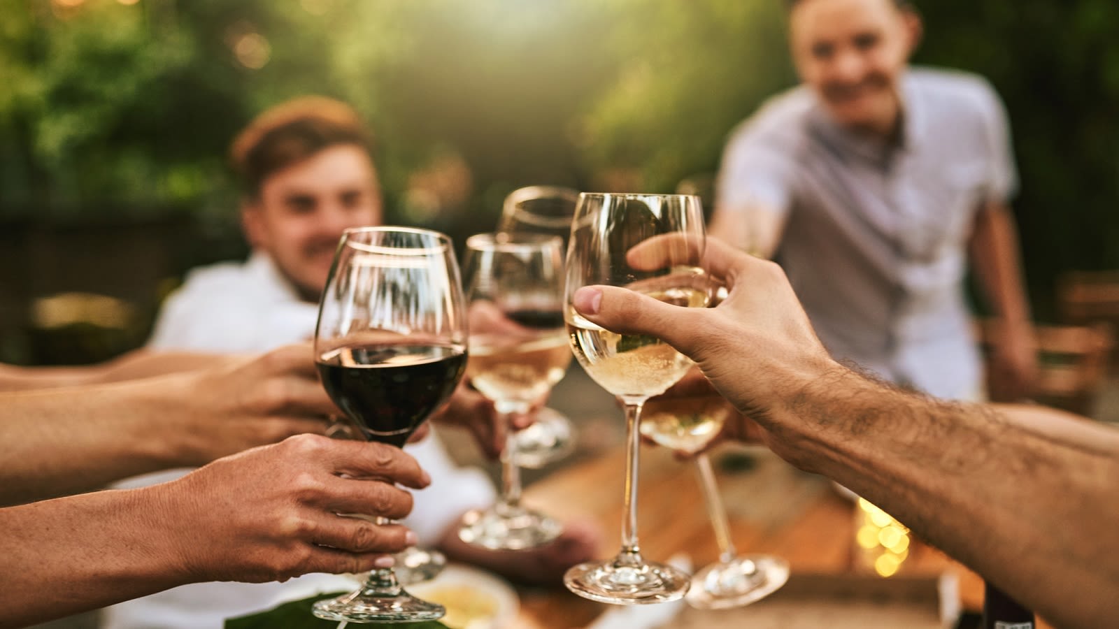 Outdoors toasting glasses of wine