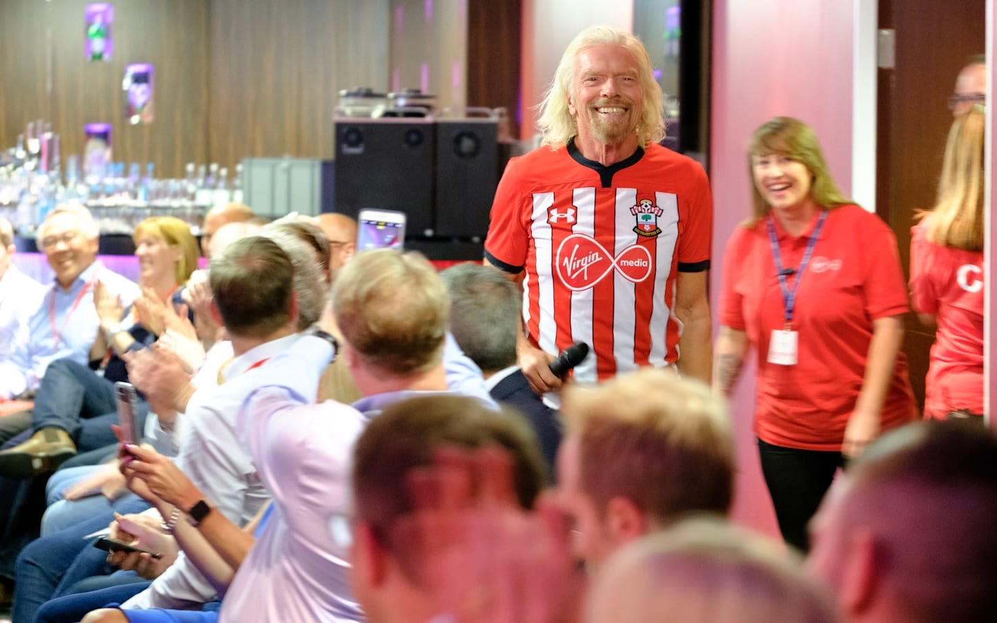 Richard Branson wearing a Southampton FC football shirt with the Virgin Media logo on