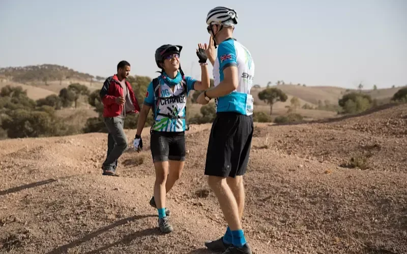 Two cyclists high-five on the 2018 Strive Challenge in Morocco