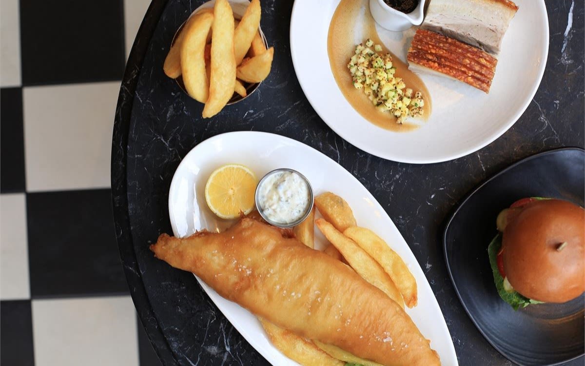 Image of fish and chips, a pork dish, and a burger at Gordon Ramsey's restaurant.