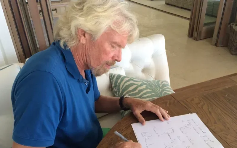 Richard Branson writing a letter