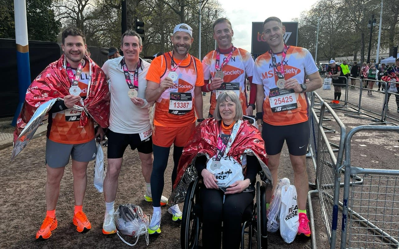 Sara Weller CBE with her support runners after finishing the 2023 London Marathon